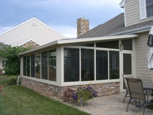 Custom sunroom that leads to outdoor patio