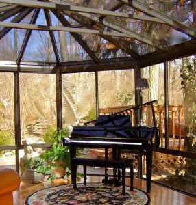 Conservatory sunroom with a piano