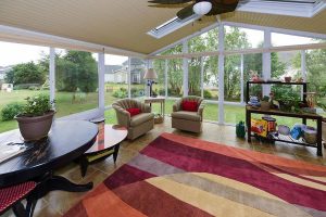 Fully furnished sunroom with gardening shelf