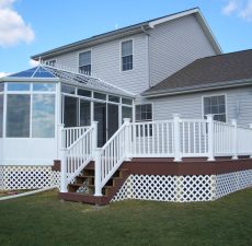Conservatory style sunroom with sliding doors to a deck