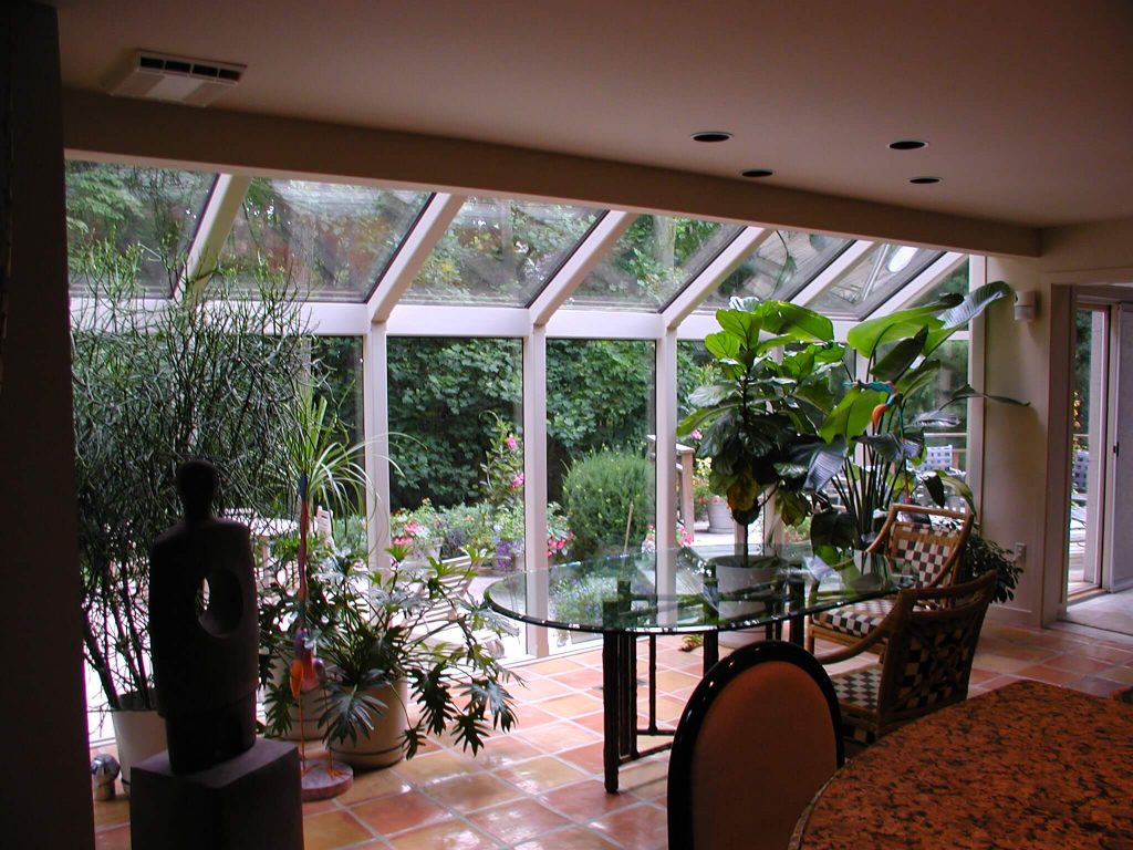 Straight roof sunroom addition overlooking a garden