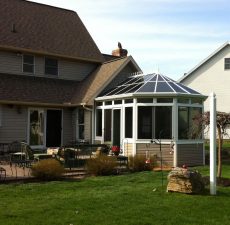 Conservatory sunroom connected to a patio