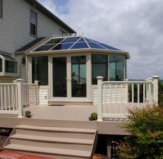 Conservatory style sunroom with doors to a deck