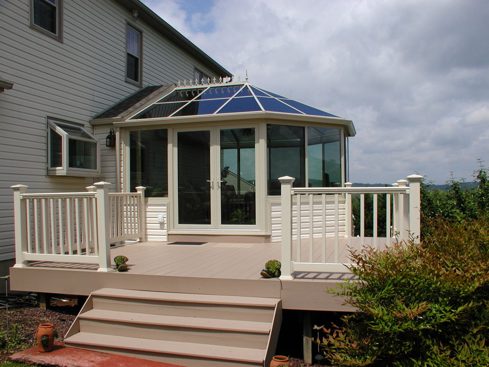 Conservatory style sunroom with doors to a deck