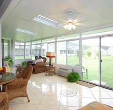 Couple enjoying time in solid straight roof sunroom installation
