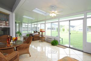 Couple enjoying time in solid straight roof sunroom installation