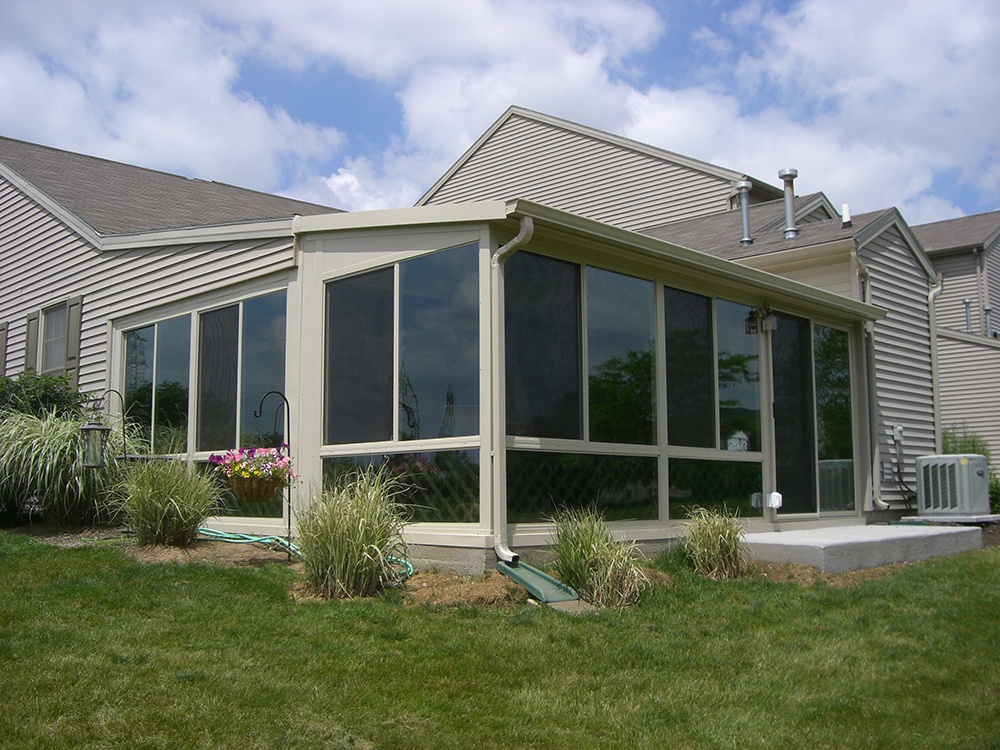 Solid roof sunroom installed back of house