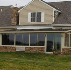 installed backyard solid roof sunroom with walkout sliding doors