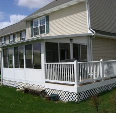 solid roof sunroom installation connected to deck