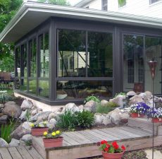 Patio enclosure next to a pond and garden